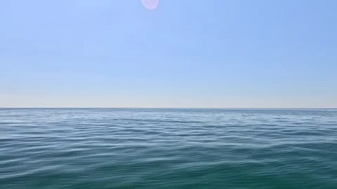 Sea water surface. Low angle view over clear azure sea water. Sun glare Stock Footage 255198890