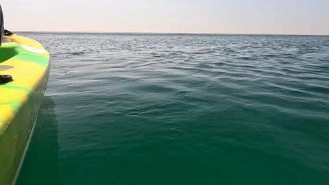 Sea water surface. Low angle view from kayak, camera flies over the clear green Stock Footage 255276370