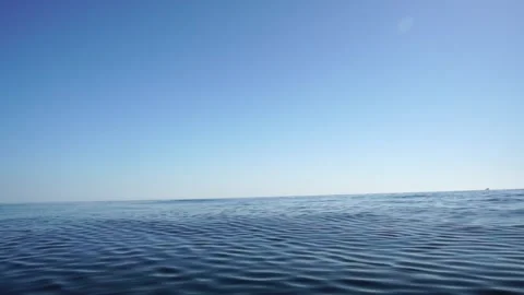 Sea water surface. Low angle view over clear azure sea water. Sun glare Stock Footage 265222584