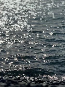 Sea water surface with sunlight reflection and moving waves Stock Photos