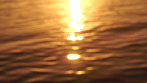 Sea water surface sunset. Low angle view over golden sea water. Sun glare Stock Footage 260793677