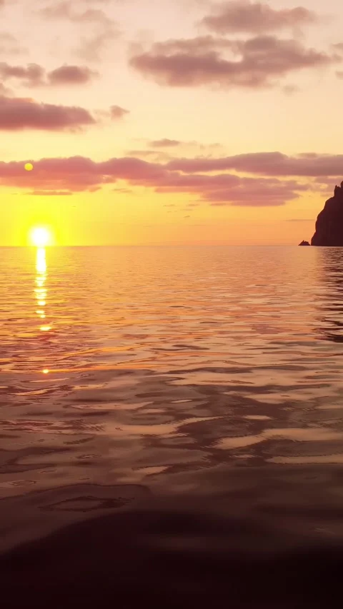 Sea water surface at sunset. Vertical aerial view, camera flies over calm golden Stock Footage 255559468