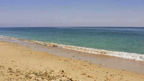 Sea water washes clean empty sandy wild beach, calm sea or ocean, tide or low Stock Footage 126925251