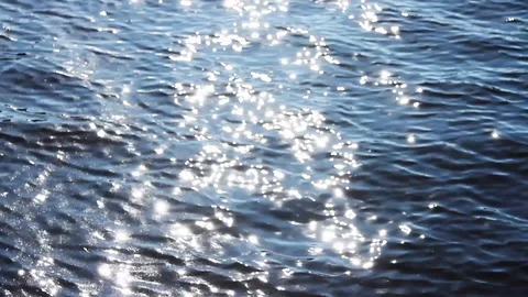 Sea water waves with sun reflections with blur in the beginning Stock Footage 128229851