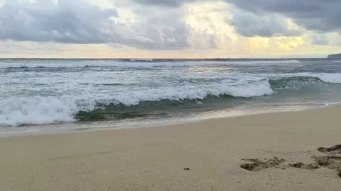 Sea wave on the beach at sunset time Kedung tumpang beach in Tulungagung, E.. Stock Footage 310010570
