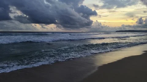 Sea wave on the beach at sunset time Kedung tumpang beach in Tulungagung, E.. Stock Footage 310010757