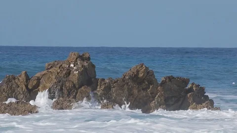 Sea wave beats on a big stone. Sunny day Stock Footage 74968438
