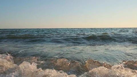 Sea wave close up, low angle view, sunrsie slow motion video Stock Footage 96252797