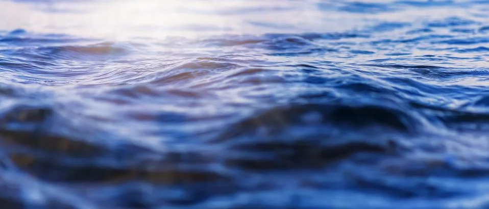 Sea wave close up with low angle view sunrsie shot. Background texture for te Stock Photos