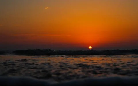 Sea wave close up, low angle view of a sunset on the ocean. Stock Photos