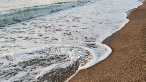 Sea wave close-up rolls on the sandy beach. Stock Footage 152277338