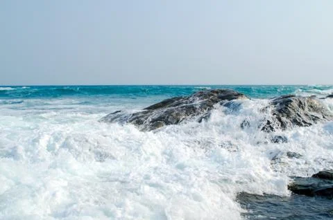 The sea wave is crashed about the shore and rocks. Stock Photos