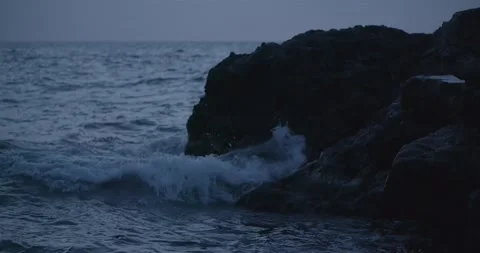 Sea wave crashes into rocks and splashing spectacular slow motion Stock Footage 130404013