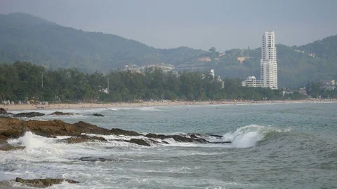 Sea wave hit the rock shore seascape , Patong sand beach Phuket tree and moun Stock Footage 91234958