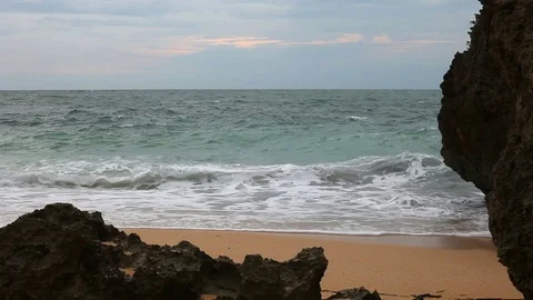 Sea wave hit the rocks on the sandy beach Stock Footage 73462447