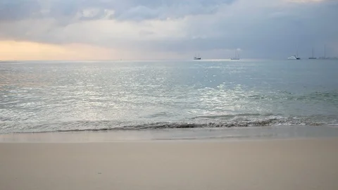 Sea wave hit sand beach with horizon skyline, yacht boat park in ocean Video stock 99501320