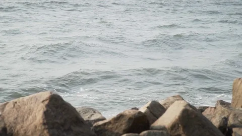 Sea wave hitting rocks beach summer stone evening sunset above view slow motion Stock Footage 107877209