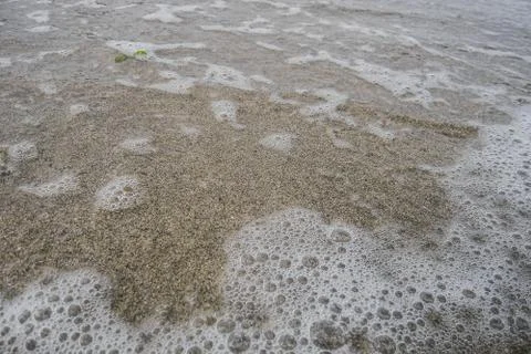 Sea wave over sand Stock Photos