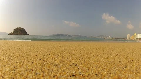 Sea wave roll on camera at sand sunny summer beach on background of stones Stock Footage 48266547