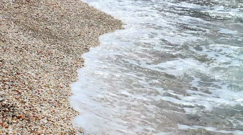 Sea wave rolled ashore covered with shells . Stock Footage 49500088