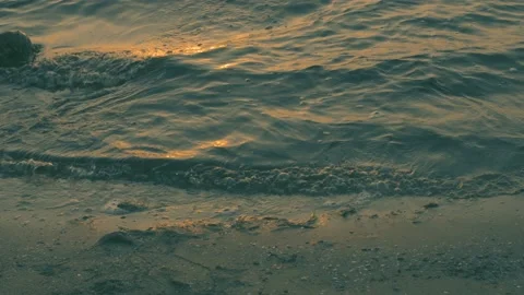 Sea wave on the sand of the beach, close-up view, golden, 4K Stock Footage 90985510