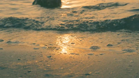 Sea wave on the sand of the beach, close-up view, golden, 4K Stock Footage 90991305
