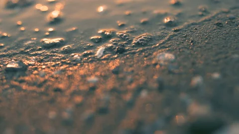 Sea wave on the sand of the beach, close-up view, golden, 4K Video stock 90993714