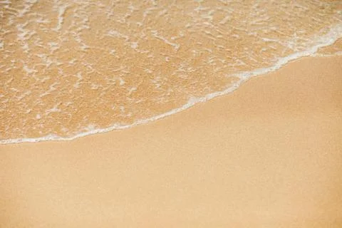 Sea wave to the sandy beach Stock Photos