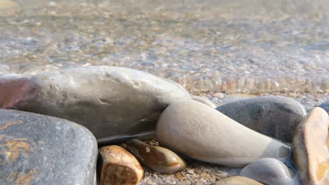 The sea wave slowly washed away the stones against the background Stock Footage 160430726