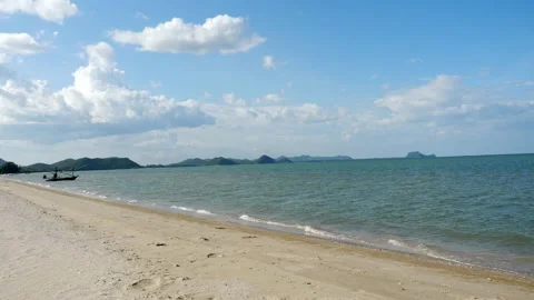 Sea wave splash the brown sand beach with blue sky and white cloud Stock Footage 132936484