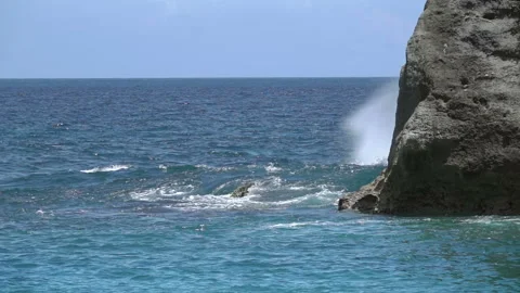 Sea Wave with Splashes Breaks over a Rock. Slow Motion Видео 106460341