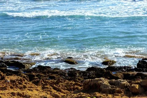 Sea wave texture and turquoise water near cliffs. Stock Photos