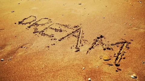 Sea Wave Washes Away The Drawing Of A Dream On Sand Video stock 78612201