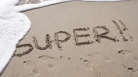 A sea wave washes away the text written on the sand from the beach - Super. Stock Footage 254502139