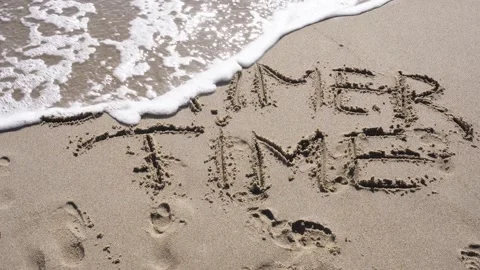 A sea wave washes away the text written on the sand from the beach - Summer time Stock Footage 255306187