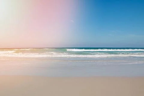 Sea wave with white foam rolling on the beach sand. Stock Photos
