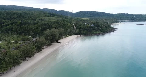 Sea wave on white sand beach with green tree forest island aerial view Stock Footage 104311456
