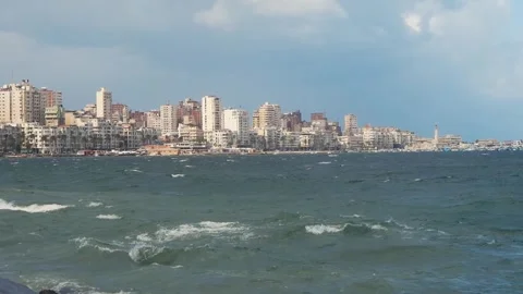 Sea Waves and Distant Buildings of a Big City (Alexandria, Egypt) Stock Footage 243094869
