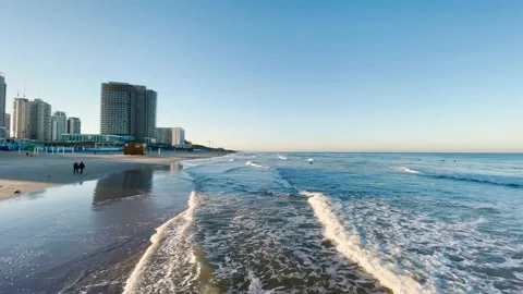 Sea waves and empty sandy beach at sunrise Stock Footage 147043681