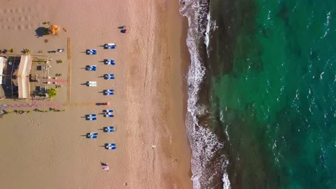 Sea waves and sandy beach with sunbeds Stock Footage 224874017