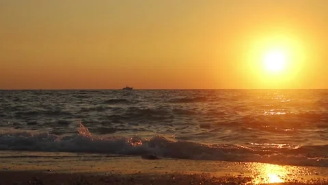 Sea, waves and a ship at sunset Stock Footage 160214154