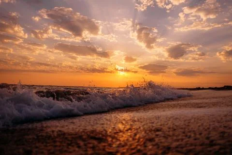 Sea waves and sunset. Stock Photos