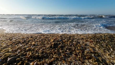 Sea waves approach the camera. Summer slow motion. Pebble sand Stock Footage 276709325