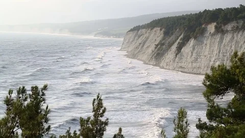 The sea waves are beating against the rocky shore. Stock Footage 79811388