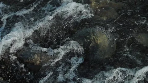 Sea waves are beating against the rocks on the coastline. Video with dark blue Stock Footage 192995669