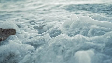 Sea waves are beating against stones close up. Slow motion 4x. Background Stock Footage 296228915