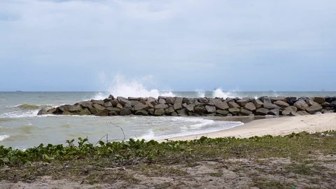Sea waves are blasted with artificial rocks. 動画素材 93898545
