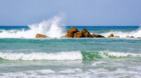 Sea waves are bouncing hard onto stones Stock Photos