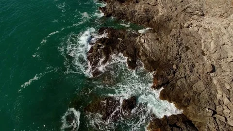 Sea waves are foaming hitting the coastal rocks. Top view Stock Footage 278701367