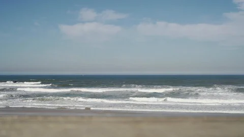 Sea waves on beach with cloudy sky in slow motion, Portugal Stock Footage 129067916